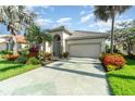 Charming home featuring lush landscaping, a tile roof, and a well-manicured lawn at 13376 Golf Pointe Dr, Port Charlotte, FL 33953