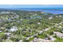 An aerial view shows the property's location near water and surrounding greenery at 1550 Bayshore Dr, Englewood, FL 34223