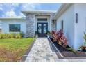 A lovely, stone walkway leads to the home's double door entry with decorative wreaths at 15610 Staunton Cir, Port Charlotte, FL 33981