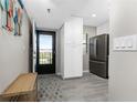 Entryway with a view of the kitchen featuring stainless steel appliances and white cabinets at 1591 Beach Rd # 402, Englewood, FL 34223
