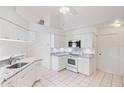 Bright kitchen with white cabinetry, granite countertops, and modern stainless steel appliances at 18112 Windswept Av, Port Charlotte, FL 33948