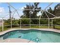 Enjoy this screened-in outdoor pool with sunny skies above, perfect for relaxation and entertainment at 18112 Windswept Av, Port Charlotte, FL 33948