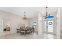 Elegant dining room featuring a stylish chandelier, a large table, and bright natural light at 22 Par View Rd, Rotonda West, FL 33947