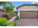 Charming single-story home with brick walkway, mature landscaping and a two-car garage at 2592 Brassica Dr, North Port, FL 34289