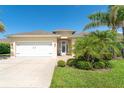 Charming home featuring a well-maintained lawn, landscaping, and a spacious two-car garage at 267 Talquin Ct, Englewood, FL 34223