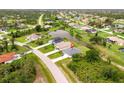 Aerial view of home on a large lot with mature landscaping and a pond in a quiet neighborhood at 271 Antis Dr, Rotonda West, FL 33947