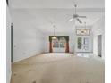Expansive living room with high ceilings, arched windows, and elegant lighting fixtures, ready for personal touches at 365 Capstan Dr, Placida, FL 33946