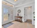 Bright foyer features tile flooring, decorative table, and an elegant front door at 423 Boundary Blvd, Rotonda West, FL 33947