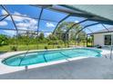 Inviting screened-in pool area with a serene view of the lush backyard at 423 Boundary Blvd, Rotonda West, FL 33947