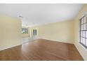 Spacious living room with hardwood floors and a smooth transition to the tiled kitchen space at 4371 Tollefson Ave, North Port, FL 34287