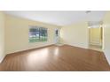Bright and airy living room with a large window, showcasing hardwood floors at 4371 Tollefson Ave, North Port, FL 34287