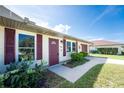 A sidewalk leads to the front entry of this well maintained house with pretty landscaping at 4399 Mundella Cir, Port Charlotte, FL 33948
