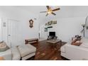 Spacious living room featuring wood floors, vaulted ceiling, ceiling fan, and ample natural light at 4399 Mundella Cir, Port Charlotte, FL 33948