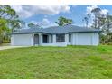 Charming single-story home with a well-kept lawn and attached garage at 5412 Ulysses St, Port Charlotte, FL 33981