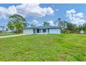 Inviting single-story home with attached garage, manicured lawn, and a welcoming front entrance at 5412 Ulysses St, Port Charlotte, FL 33981
