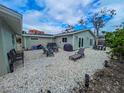 An expansive outdoor space, complete with seating, barbecue, and lush foliage at 608 Saint Judes Dr, Longboat Key, FL 34228