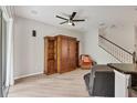 Comfortable living room featuring hardwood floors, a media center, and stairs leading to the upper level at 8228 Villa Grande Ct, Sarasota, FL 34243