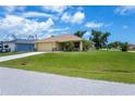 Single-story home with manicured lawn, showcasing its well-maintained exterior and curb appeal at 9325 Crugar Ter, Englewood, FL 34224