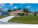 Inviting single-story home with a well-manicured lawn and attached two-car garage at 9325 Crugar Ter, Englewood, FL 34224