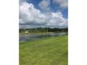 Scenic lake view with lush green grass in a beautiful community at 10258 Morning Mist Ln, Sarasota, FL 34241
