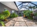 Spacious outdoor patio with beautiful stone floors and screened ceiling at 10487 Coquina Ct, Placida, FL 33946