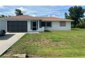Well-kept home with a spacious yard, complemented by a screened-in entrance at 11029 Vanessa Ave, Englewood, FL 34224