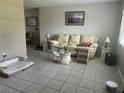 Cozy living room with neutral walls, tile floor, and comfortable seating at 11029 Vanessa Ave, Englewood, FL 34224