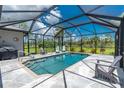 Screened-in pool area featuring lounge chairs and flagstone patio at 1119 Boundary Blvd, Rotonda West, FL 33947