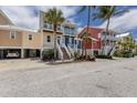 Attractive multi-story home with carport, palm trees, and well-maintained landscaping at 11780 Anglers Club Dr # 107, Placida, FL 33946