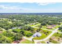 Wide shot of the property highlighting its location within a community surrounded by trees at 123 Ferdon Cir, Port Charlotte, FL 33954