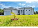 Attractive single-story home with a well-manicured lawn and appealing curb appeal at 123 Ferdon Cir, Port Charlotte, FL 33954