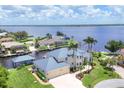 Beautiful waterfront property with lush landscaping, private boat dock, and scenic water views at 12438 Prather Ave, Port Charlotte, FL 33981