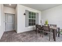 Private patio with dining set and stylish outdoor decor at 12550 Galapagos Ct # 104, Venice, FL 34293