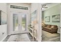 Bright foyer with a decorative console table and view into the living room at 1269 N Lavina St, North Port, FL 34286