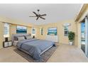 Bright bedroom with fan, walk-out access, and neutral walls at 127 Jennifer Dr, Rotonda West, FL 33947