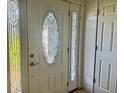 Elegant front door with decorative glass detailing and sidelights at 133 Paddington Rd, Venice, FL 34293