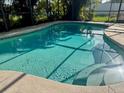Sparkling pool with clear blue water, surrounded by a screened-in enclosure at 133 Paddington Rd, Venice, FL 34293