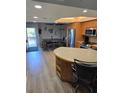 Bright kitchen with wood cabinets, stainless steel appliances, and breakfast bar with seating at 1401 S Mccall Rd # 101, Englewood, FL 34223