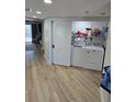 Convenient laundry area with a full-size washer and dryer neatly tucked behind a sliding door at 1401 S Mccall Rd # 101, Englewood, FL 34223