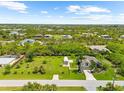 Gorgeous landscaped yard with a charming residence nestled among lush greenery and mature palm trees at 15521 Lakeland Cir, Port Charlotte, FL 33981