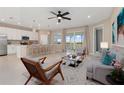 Bright, open-concept living area with a modern kitchen, stylish furniture, and seamless access to the outdoors at 17605 Boracay Ct # 201, Venice, FL 34293