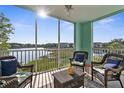 Relax on the screened balcony with comfortable seating and stunning lake views at 19375 Water Oak Dr # 203, Port Charlotte, FL 33948