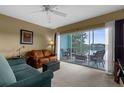 Inviting living room with comfortable seating and sliding glass doors to a patio overlooking the lake at 19375 Water Oak Dr # 203, Port Charlotte, FL 33948