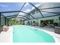 The screened-in pool area features ample seating, dining, and lounging spaces at 196 Lecturn St, Port Charlotte, FL 33954