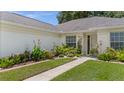 Beautifully landscaped front yard with vibrant flowers and greenery enhancing the home's curb appeal at 237 Park Forest Blvd, Englewood, FL 34223