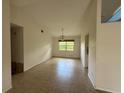 Bright living room with tile flooring and a window offering plenty of natural light at 2473 Woodyglen St, Port Charlotte, FL 33948