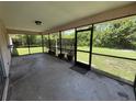 Enclosed patio with screen, providing an enjoyable outdoor living space at 2473 Woodyglen St, Port Charlotte, FL 33948
