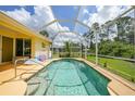 Inviting screened-in pool area, perfect for relaxing and entertaining outdoors at 2588 Westberry Ter, North Port, FL 34286
