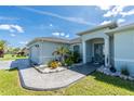 Charming single-story home with a well-maintained front lawn and meticulous landscaping surrounding the walkway to the front door at 262 Rotonda N Blvd, Rotonda West, FL 33947