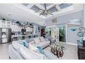Spacious living room featuring tile floors, modern decor, a large ceiling fan, and an open layout to the kitchen at 262 Rotonda N Blvd, Rotonda West, FL 33947